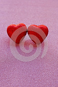 The red heart shapes on pink glitter paper background in love concept for valentines day