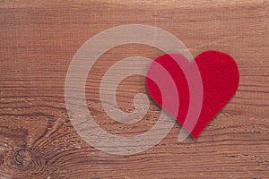 Red heart sign isolated on wooden background.