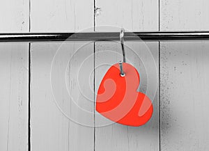 Red heart on stainless steel kitchen wall rack.