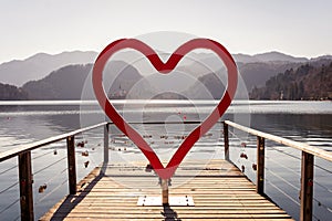 Red heart statue, lake Bled landscape with mountains, photo spot, Slovenia Slovenija