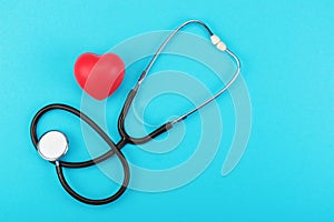 Red heart and stethoscope on a blue background.
