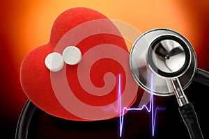 Red heart, stethoscope and pills