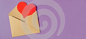A red heart tells from an envelope on a lilac background