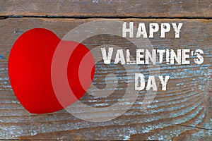 Red heart with text: happy Valentine`s day on wooden old board