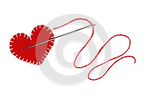 Red heart, thread and needle isolated on white