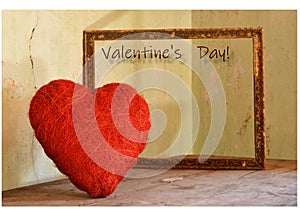 The red heart for Valentine`s Day escapes from the frame photo