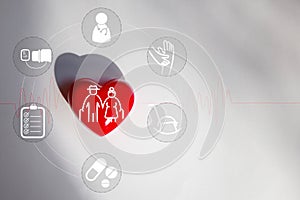 A red heart on a white paper and an elderly icon in a heart shape, a concept showing caring for elderly people