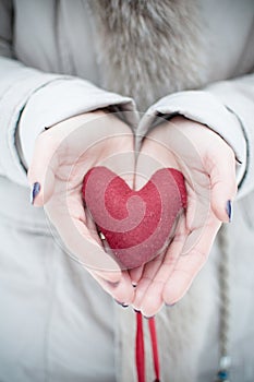 Red heart in woman hands