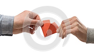 Red heart in woman and man hands. Image on isolated white background.