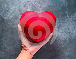 Red heart in woman\'s hand