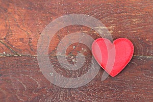 Red heart on wood background