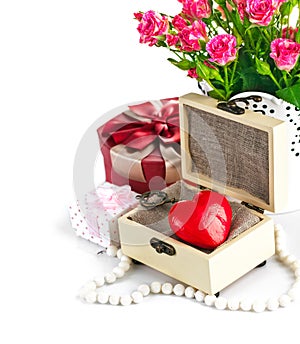 Red heart wooden casket with bunch roses