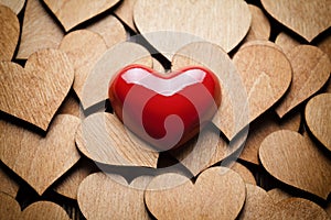 Red heart on wooden hearts background