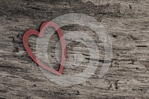 Red heart on wooden surface with copy space