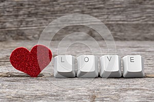 Red heart and word LOVE written on keyboard keys