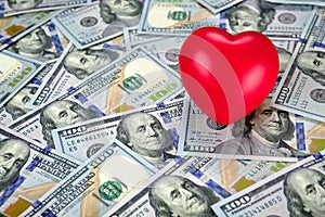 Red hearth on top of new one hundred dollar bills