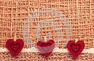 Red hearts on abstract cloth background