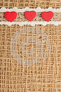 Red hearts on abstract cloth background