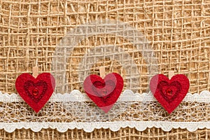 Red hearts on abstract cloth background