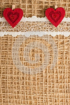 Red hearts on abstract cloth background