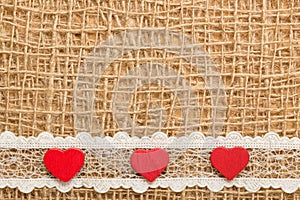 Red hearts on abstract cloth background