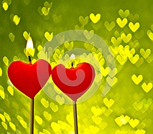 Red hearts candles on yellow hearts bokeh as background