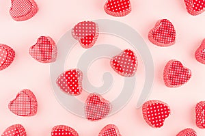 Red hearts candy on soft pink background, pattern. Valentine day abstract background.