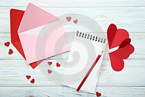 Hearts with envelopes, notebook and pencil