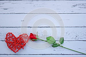 Red hearts and flowers on a white wood floor with space, ideas love or the day of love Valentines Day.