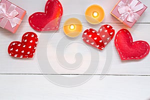 Red hearts and gift on white wooden background for Valentines day, copy space, top view