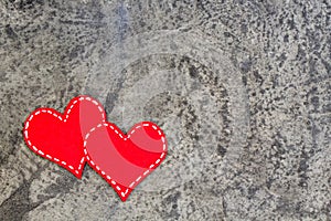 Red hearts on gray concrete background. Copy space. Top view.