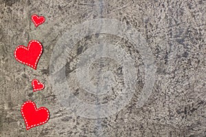 Red hearts on gray concrete background. Copy space. Top view.