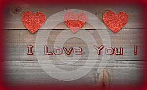 Red hearts with I Love You on wood background