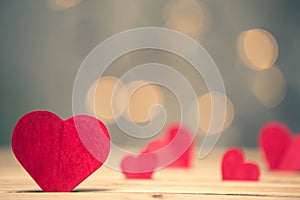 Red hearts paper on brown wooden table, Copy space to put messages on the Valentine`s Day, Red paper hearts beautiful bokeh