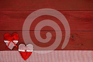 Red hearts and red gingham fabric border on antique red wood sign