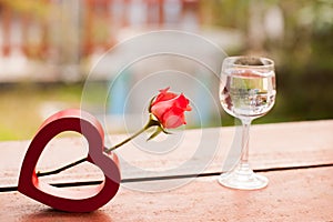 Red hearts and a roses on wooden , Valentines Day background.