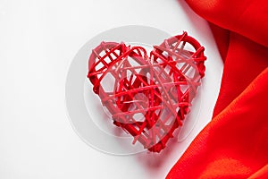 Red hearts and silk ribbon on a white background