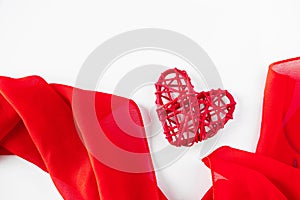 Red hearts and silk ribbon on a white background