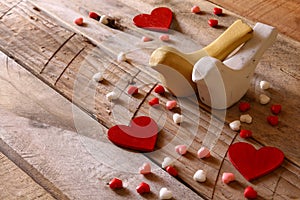 Red hearts and two loving birds on wooden table