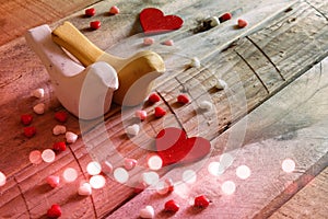 Red hearts and two loving birds on wooden table