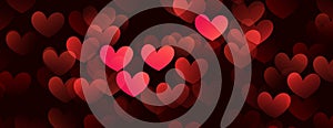 Red hearts valentine day defocused bokeh lights on a black background