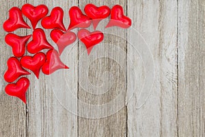 Red hearts on a weathered wood background