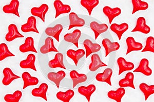 Red hearts on white fabric background