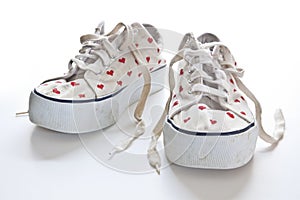 Red hearts on white sneakers