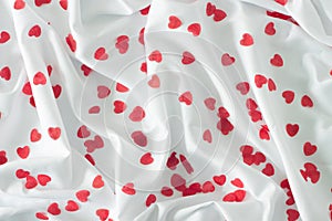 Red hearts on a white textile background