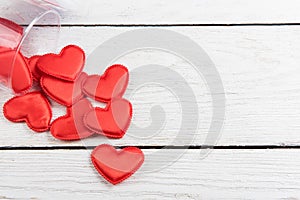 Red hearts on a white wood background