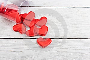 Red hearts on a white wood background