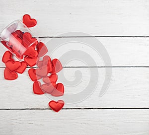 Red hearts on a white wood background