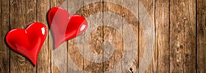 Red hearts on wood background