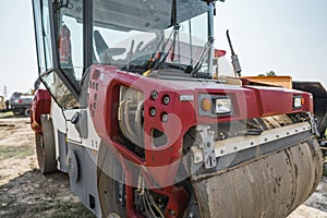 Red Heavy Vibration roller at asphalt pavement works. Road repairing. Road construction and repairing asphalt pavement